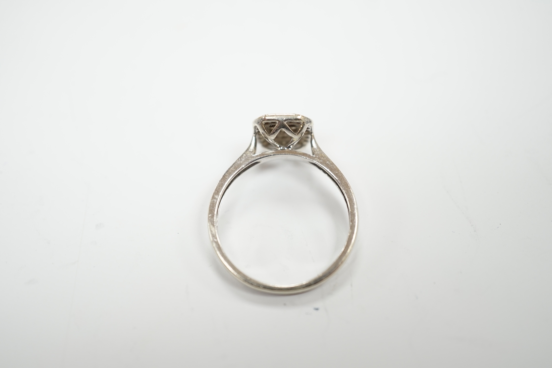 A modern 9ct white gold and diamond set cluster ring, size N, gross weight 2.5 grams.